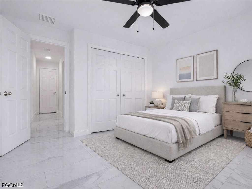 7644 19th Terrace LaBelle, FL 33935 - Photo 7 of 12 a spacious bedroom with a bed and painting on the wall