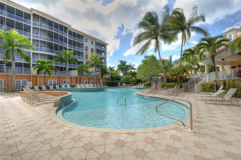 450 Launch Circle, Unit 203 Naples, FL 34108 - Photo 18 of 24 a view of a swimming pool with a sitting space