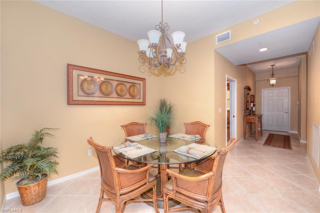 450 Launch Circle, Unit 203 Naples, FL 34108 - Photo 6 of 24 a dining room with furniture and window