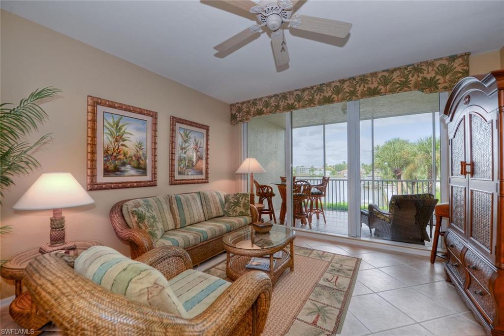 450 Launch Circle, Unit 203 Naples, FL 34108 - Photo 8 of 24 a living room with furniture and a large window