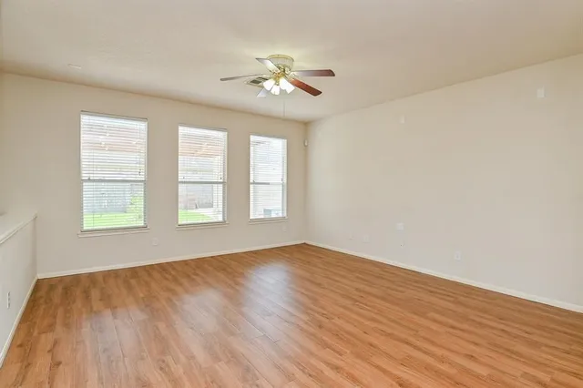 wooden floor in an empty room with a window