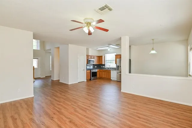 a view of a kitchen with wooden floor and a kitchen