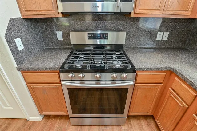 a stove top oven sitting inside of a kitchen