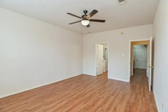 a view of an empty room and wooden floor