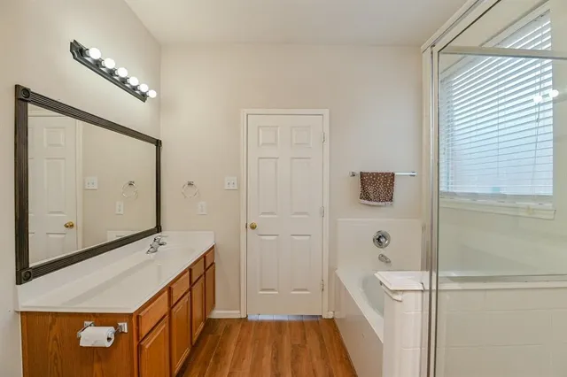 a bathroom with a sink a mirror and a shower