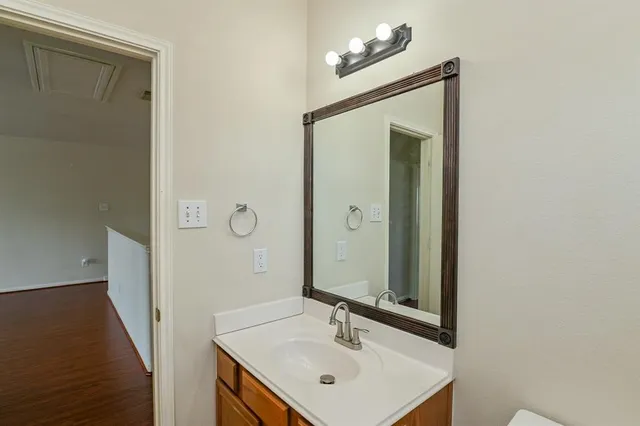 a bathroom with a sink a mirror and a vanity