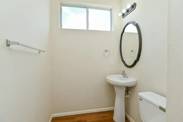 a bathroom with a sink mirror toilet and shower