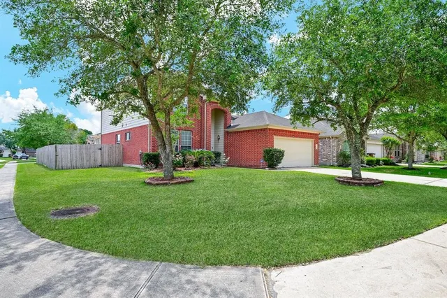 a view of a house with a backyard