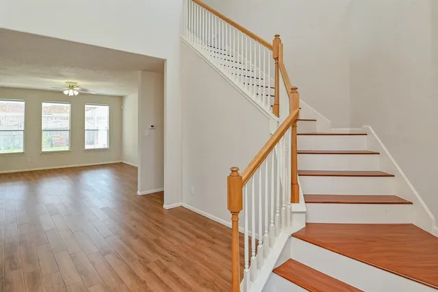 a view of an entryway with wooden floor and stairs
