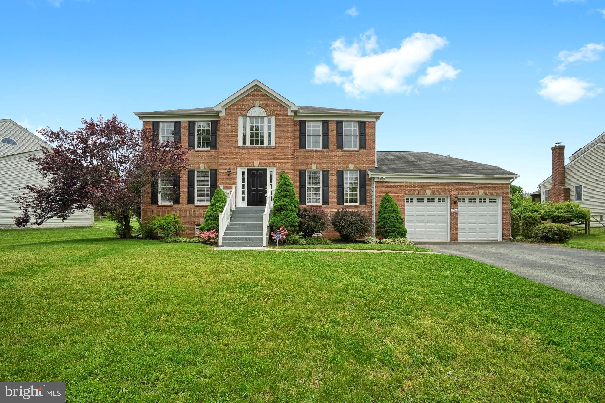 17205 Spates Hill Road Poolesville, MD 20837 - Photo 2 of 59 a front view of a house with a yard and garage