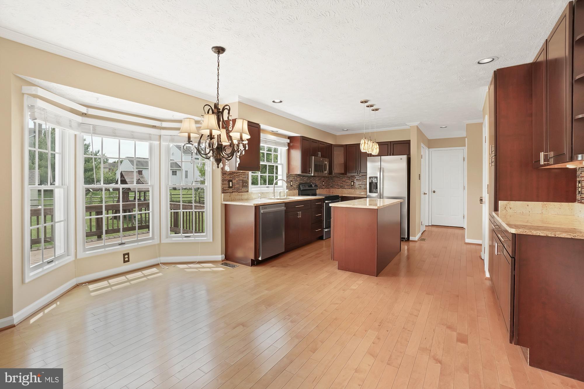 17205 Spates Hill Road Poolesville, MD 20837 - Photo 21 of 59 a view of a kitchen with a sink stove and refrigerator