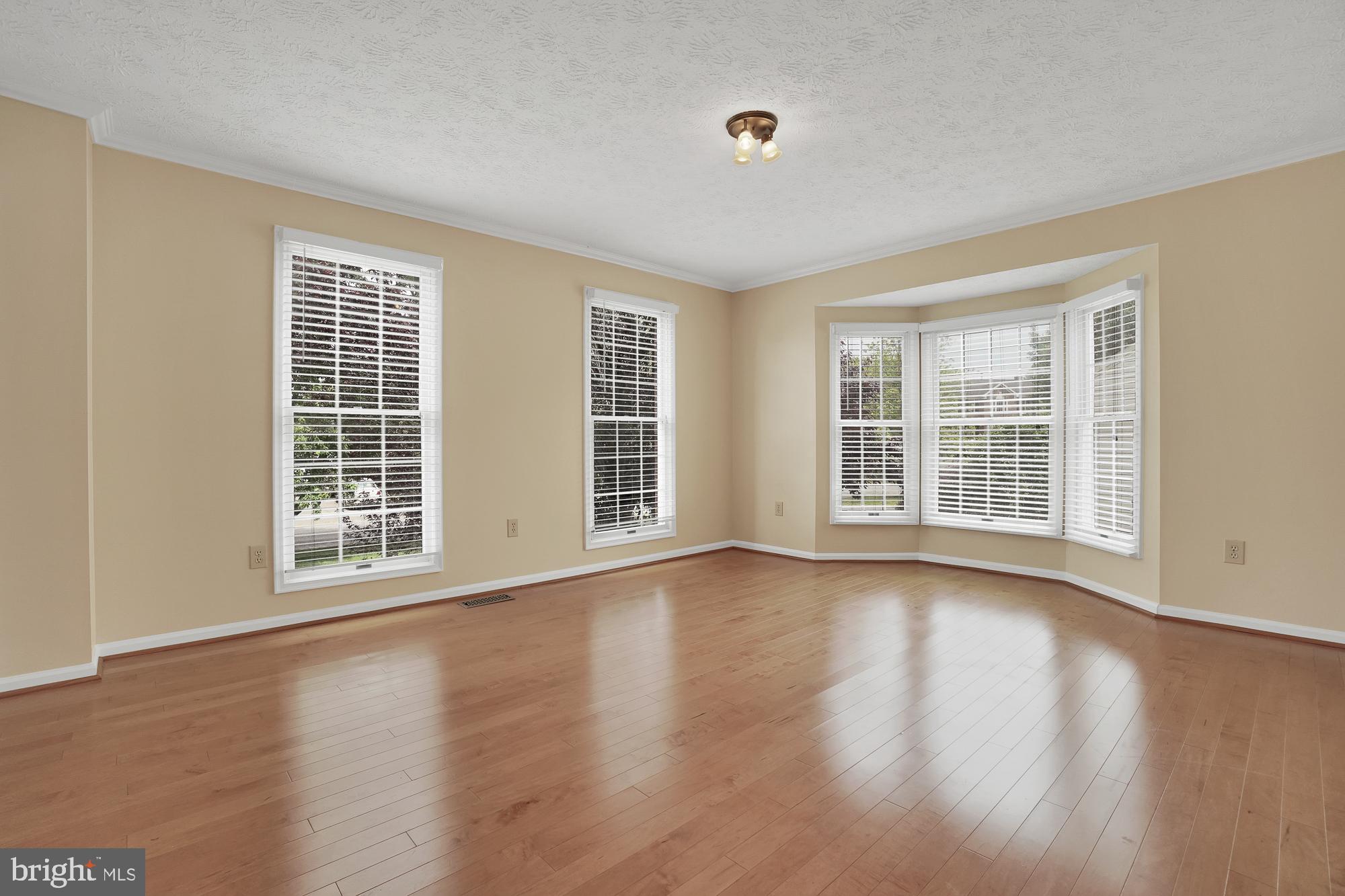 17205 Spates Hill Road Poolesville, MD 20837 - Photo 26 of 59 a view of an empty room with wooden floor and windows