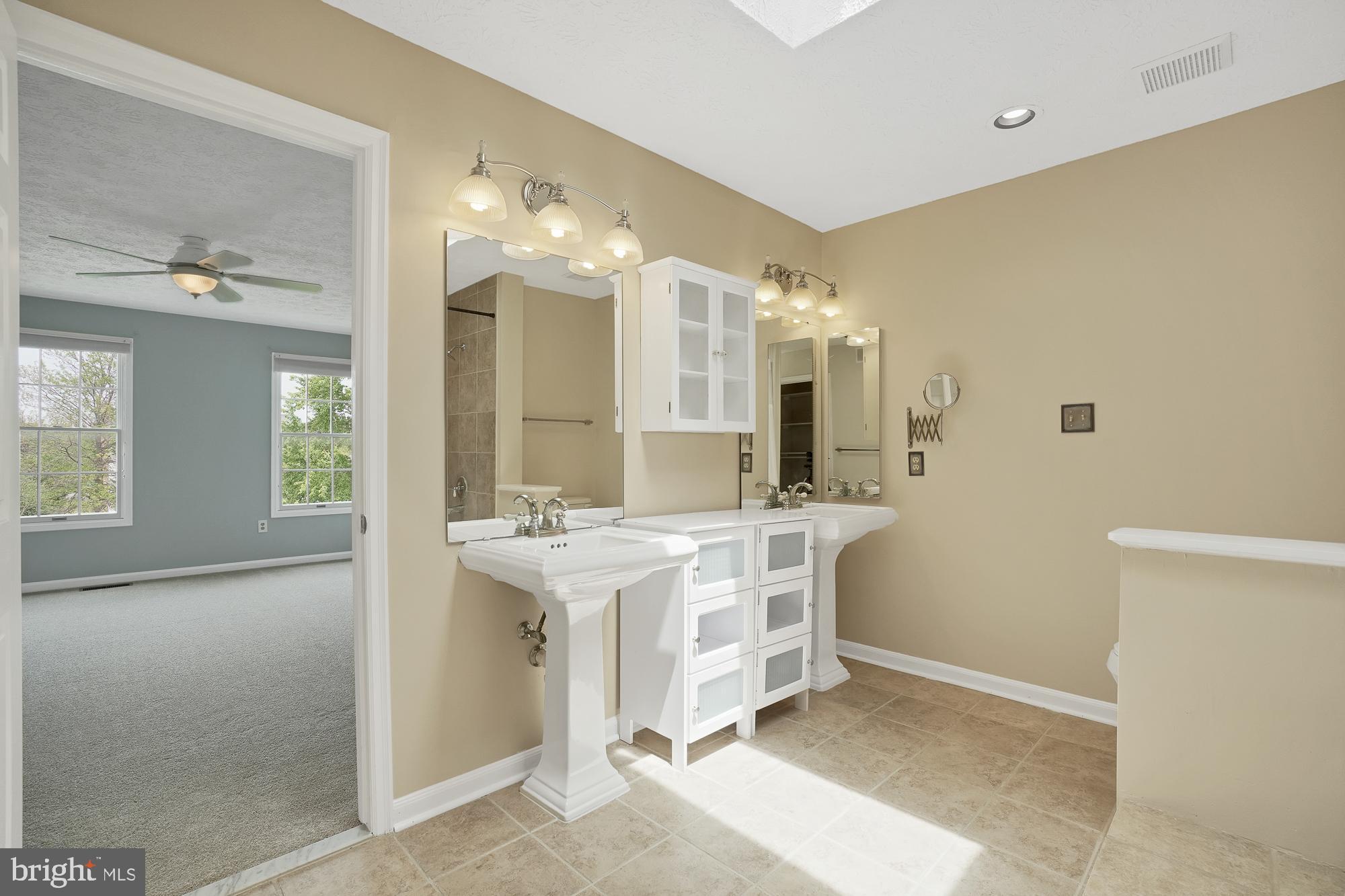 17205 Spates Hill Road Poolesville, MD 20837 - Photo 34 of 59 a bathroom with a double vanity sink mirror and