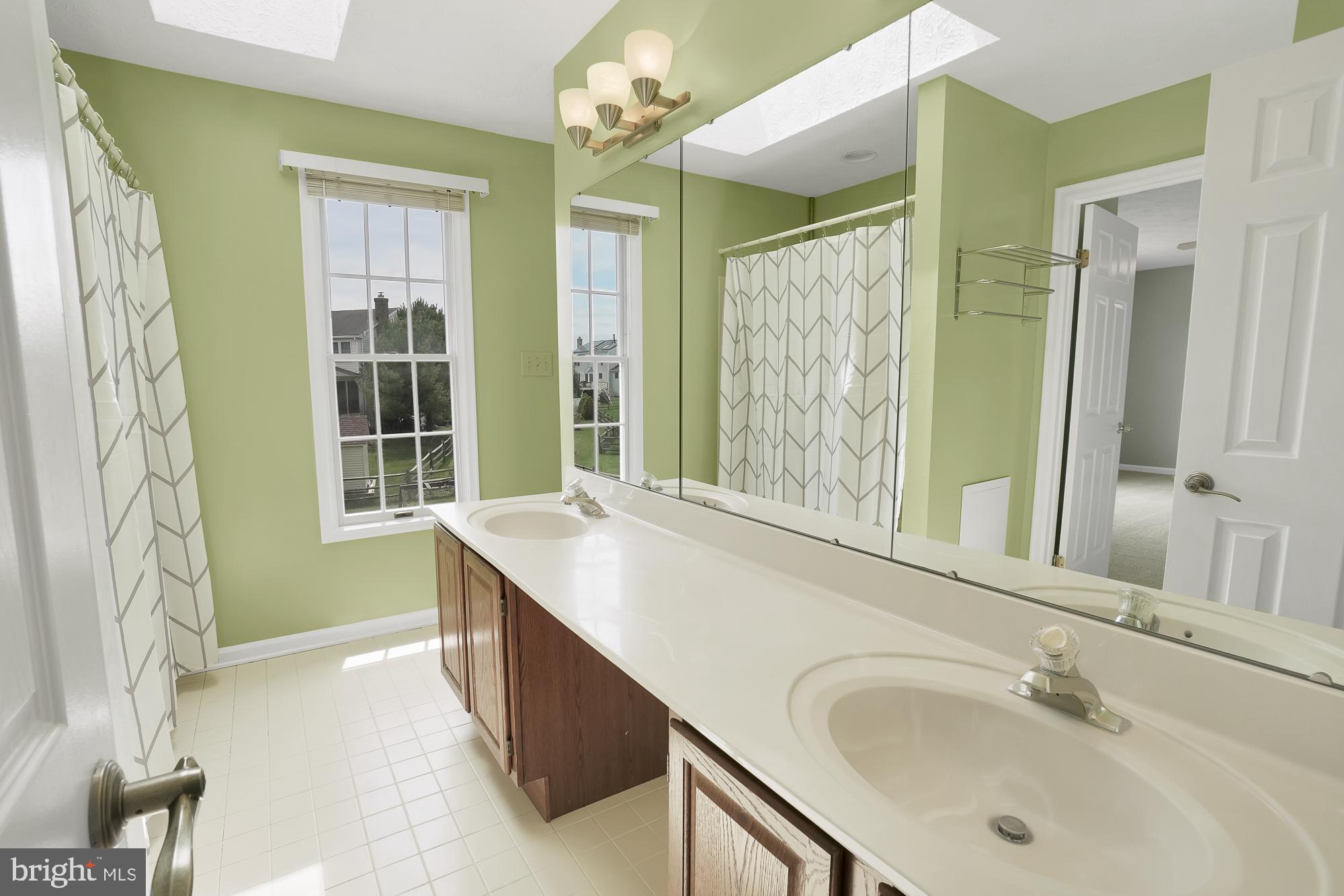 17205 Spates Hill Road Poolesville, MD 20837 - Photo 37 of 59 a bathroom with a tub sink and a mirror