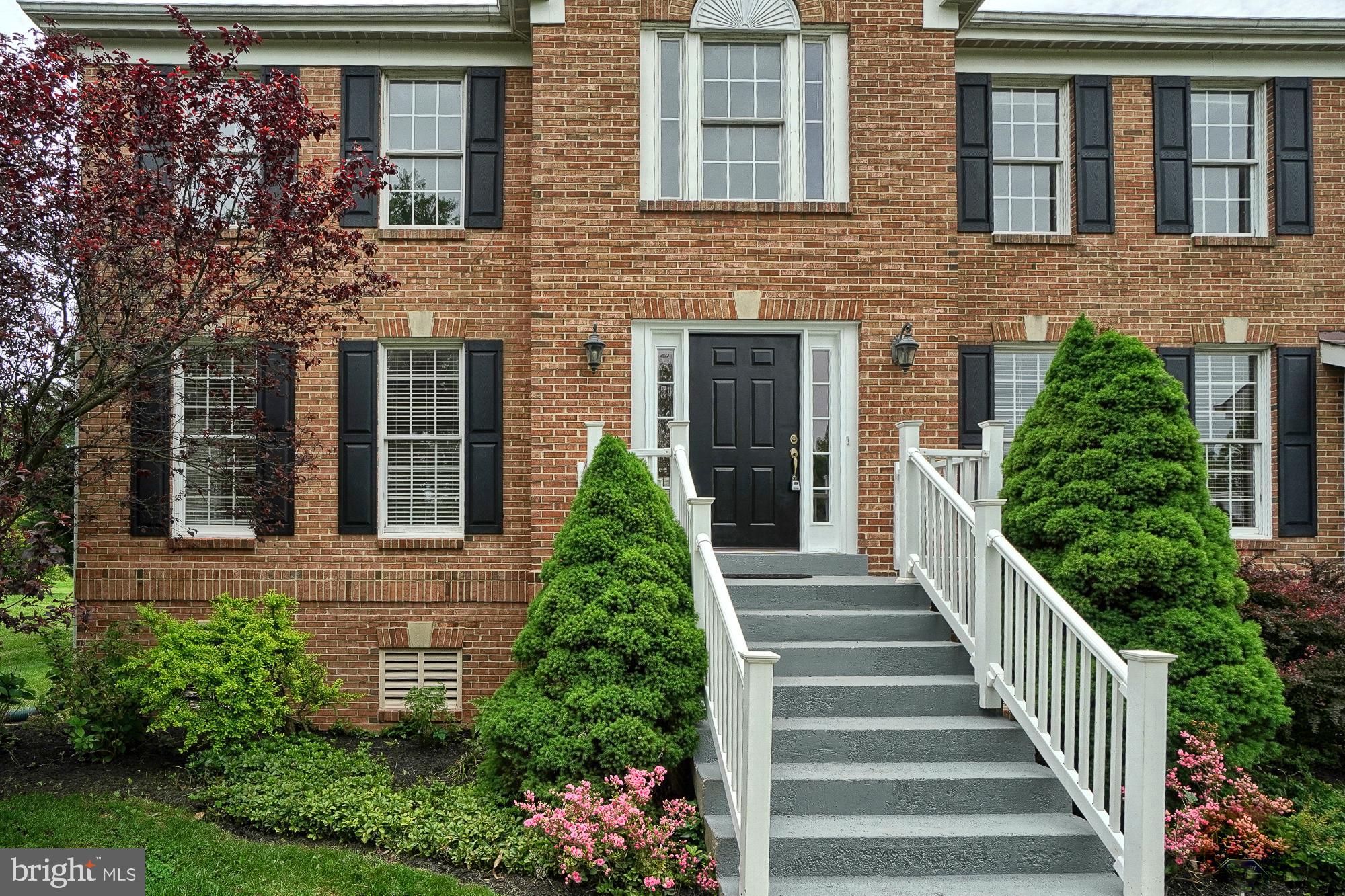 17205 Spates Hill Road Poolesville, MD 20837 - Photo 5 of 59 a view of a house with brick walls and flower plants