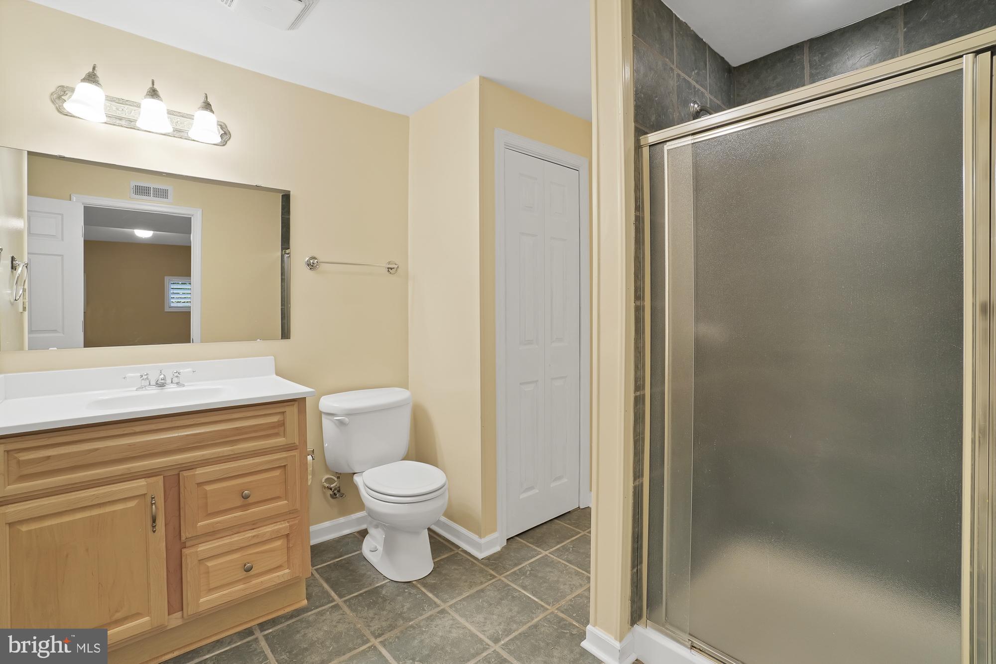 17205 Spates Hill Road Poolesville, MD 20837 - Photo 45 of 59 a bathroom with a granite countertop sink toilet and shower