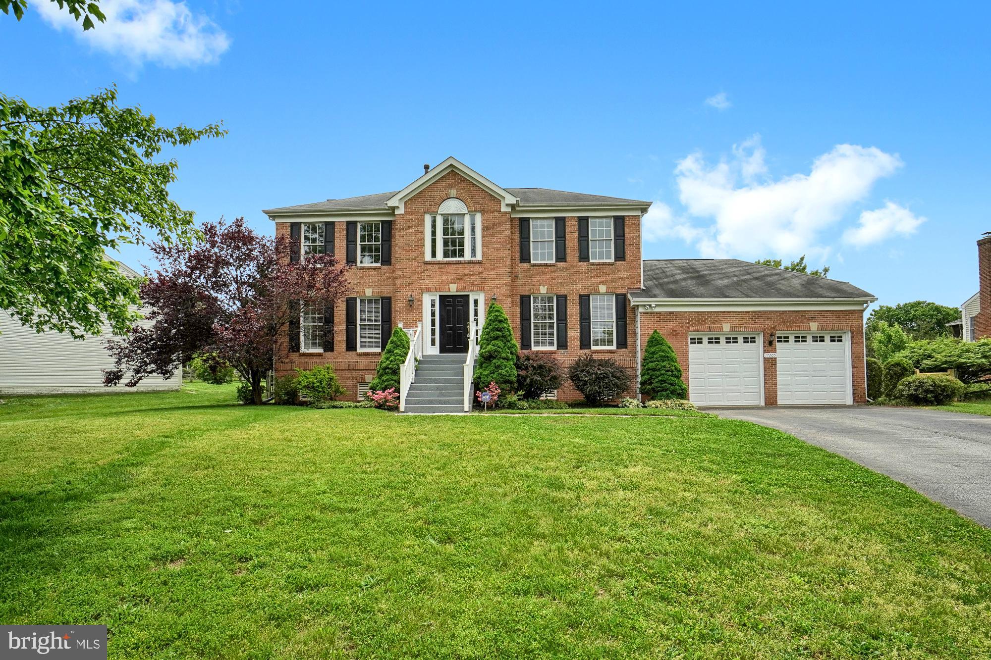 17205 Spates Hill Road Poolesville, MD 20837 - Photo 6 of 59 a front view of a house with a yard and garage