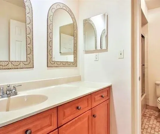 a view of a patio with table and chairs potted plants and large trees