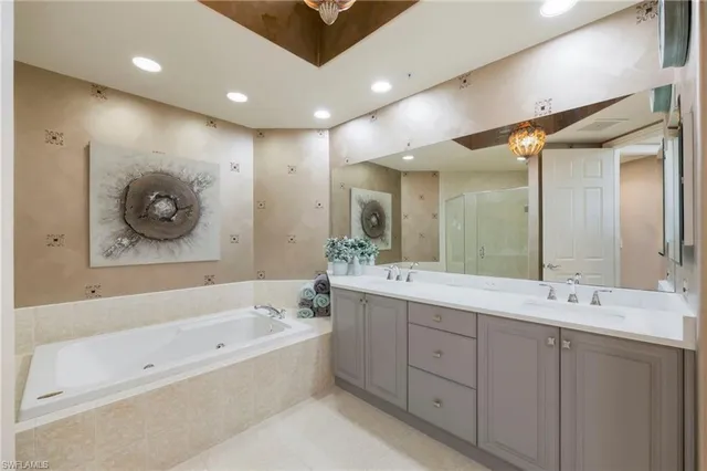 a bedroom with a bed and a chandelier fan