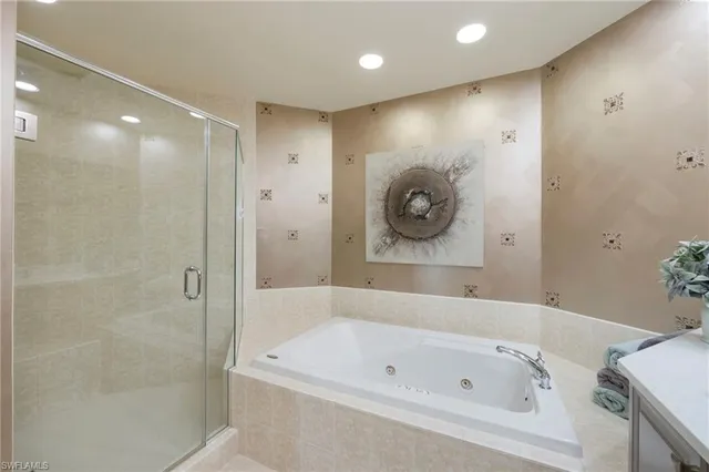 a bathroom with a toilet a sink a mirror a shower a vanity and window