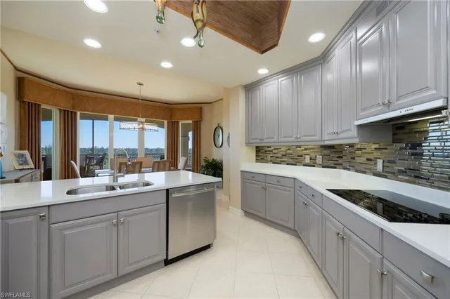 a kitchen with stainless steel appliances kitchen island granite countertop a sink and cabinets