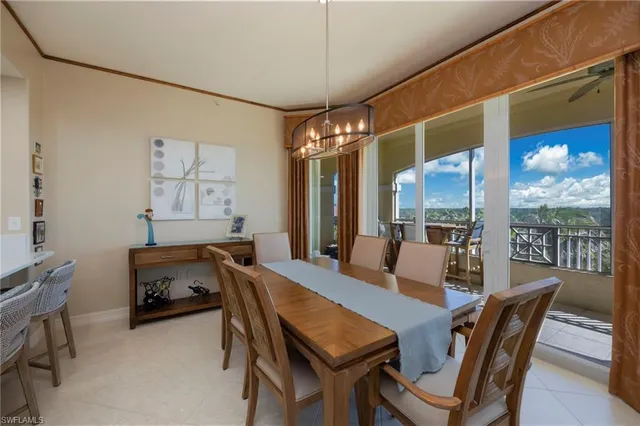 a view of a dining room with furniture and a large window