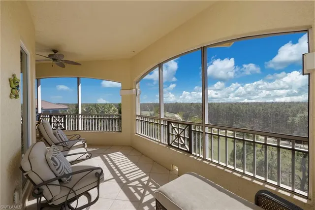 a view of a living room with furniture and floor to ceiling windows