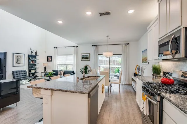 a view of a chair and table in backyard of the house