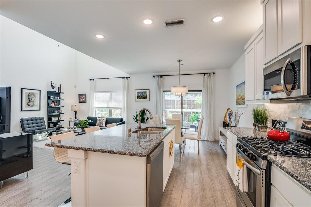 2724 Splendor Lane Little Elm, TX 75068 - Photo 25 of 25 a kitchen with granite countertop a sink stove and cabinets