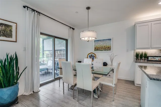 a kitchen with granite countertop a sink stove and cabinets