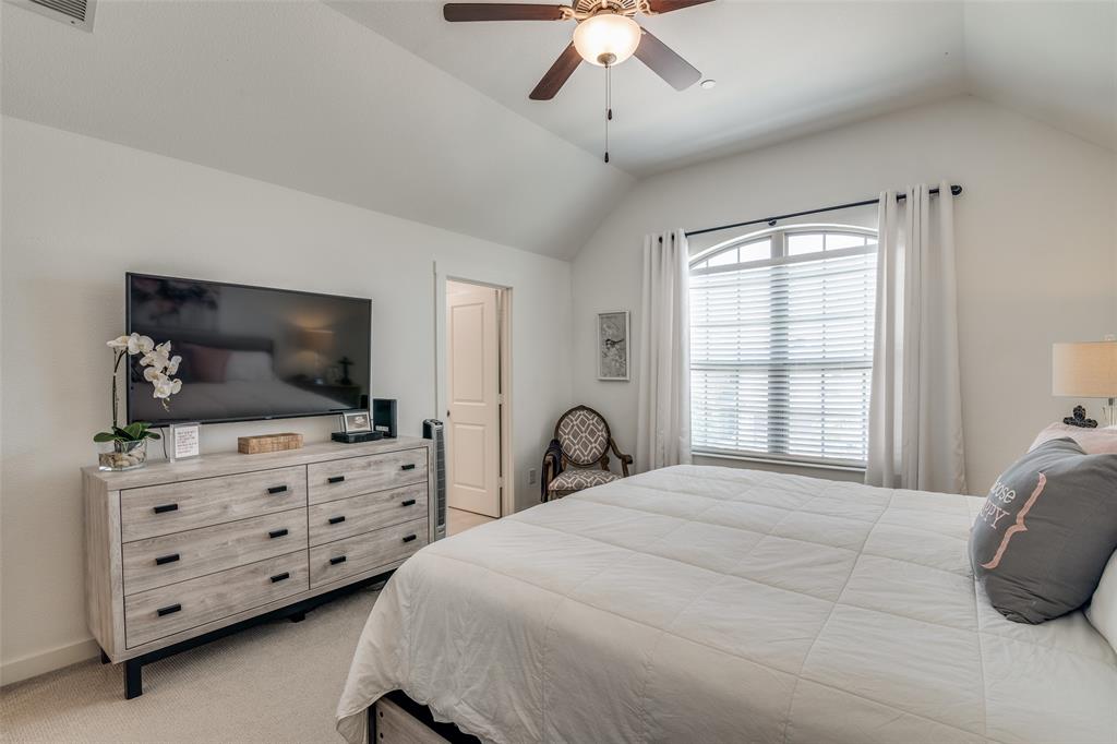 2724 Splendor Lane Little Elm, TX 75068 - Photo 15 of 25 a bedroom with a bed a flat screen tv and a window