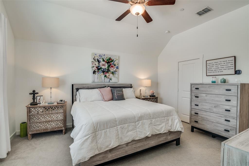 2724 Splendor Lane Little Elm, TX 75068 - Photo 16 of 25 a bedroom with a bed and a chandelier