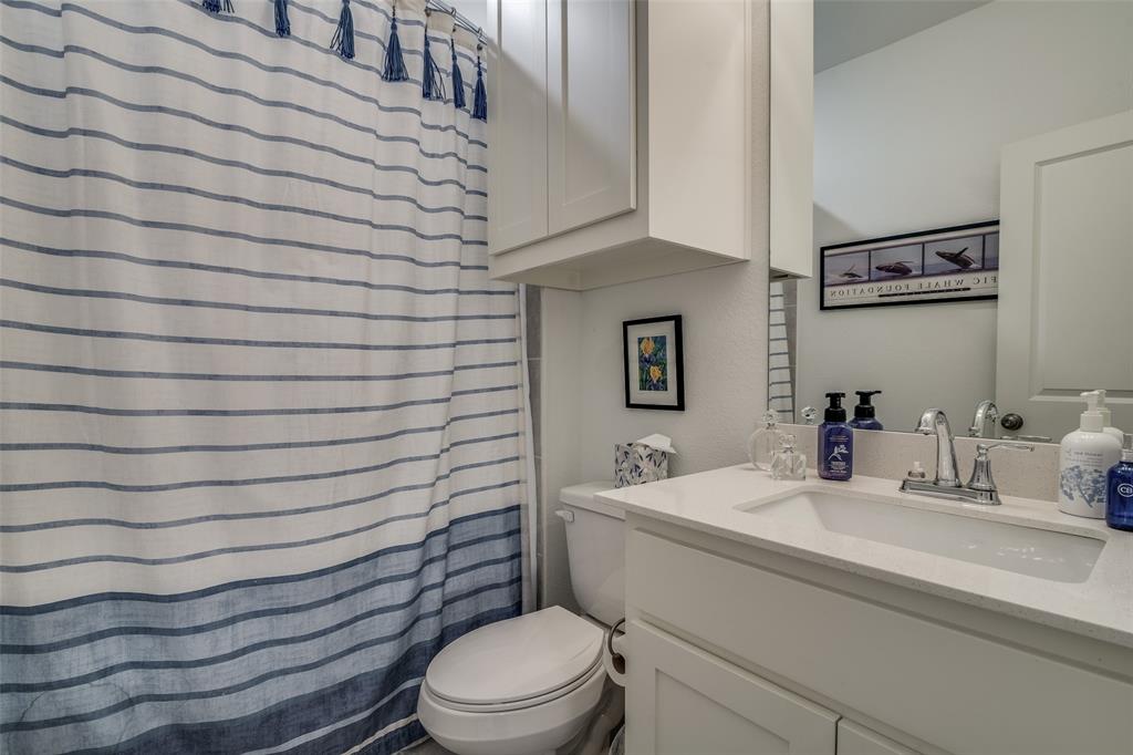2724 Splendor Lane Little Elm, TX 75068 - Photo 20 of 25 a bathroom with a sink a toilet and mirror