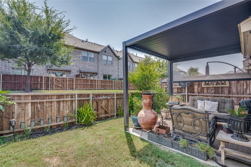 2724 Splendor Lane Little Elm, TX 75068 - Photo 23 of 25 front view of a house with a chairs and table in a patio