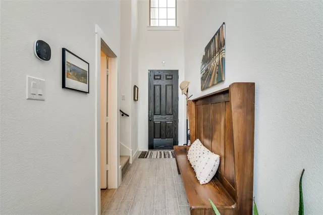 a view of a hallway with wooden floor and entryway