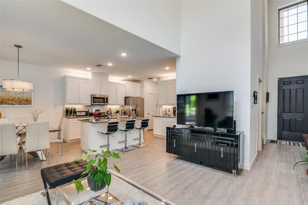 2724 Splendor Lane Little Elm, TX 75068 - Photo 7 of 25 a living room with furniture a flat screen tv and kitchen view