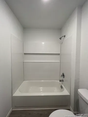 a bathroom with a bathtub and a toilet