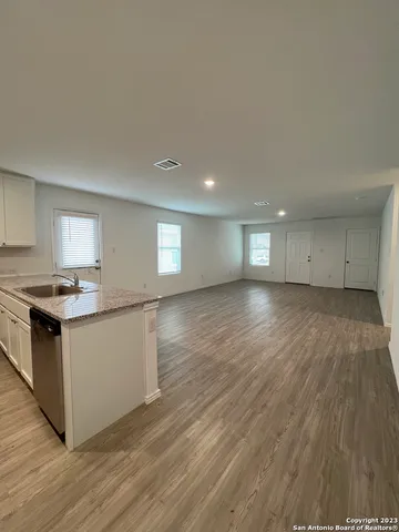 a view of kitchen with wooden floor and electronic appliances