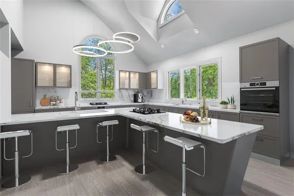 a kitchen with a sink cabinets a window and chairs