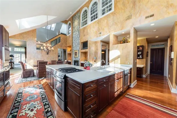 a kitchen with a stove and a wooden floor