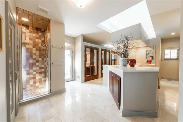 a large bathroom with a large mirror vanity and sink