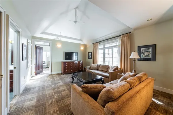 a view of a livingroom with lounge chair and a large window