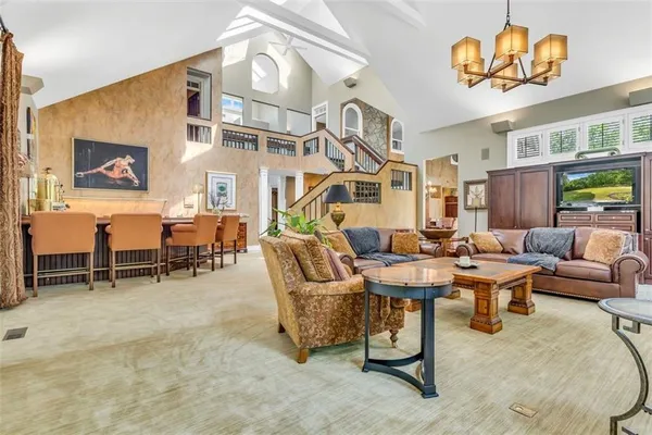 a living room with lots of furniture and a chandelier