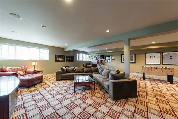 a living room with couch a dining table and kitchen view