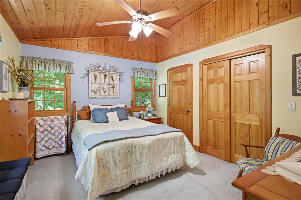 46 Spartan Lane Rabun Gap, GA 30568 - Photo 34 of 89 a spacious bedroom with a bed and a chandelier
