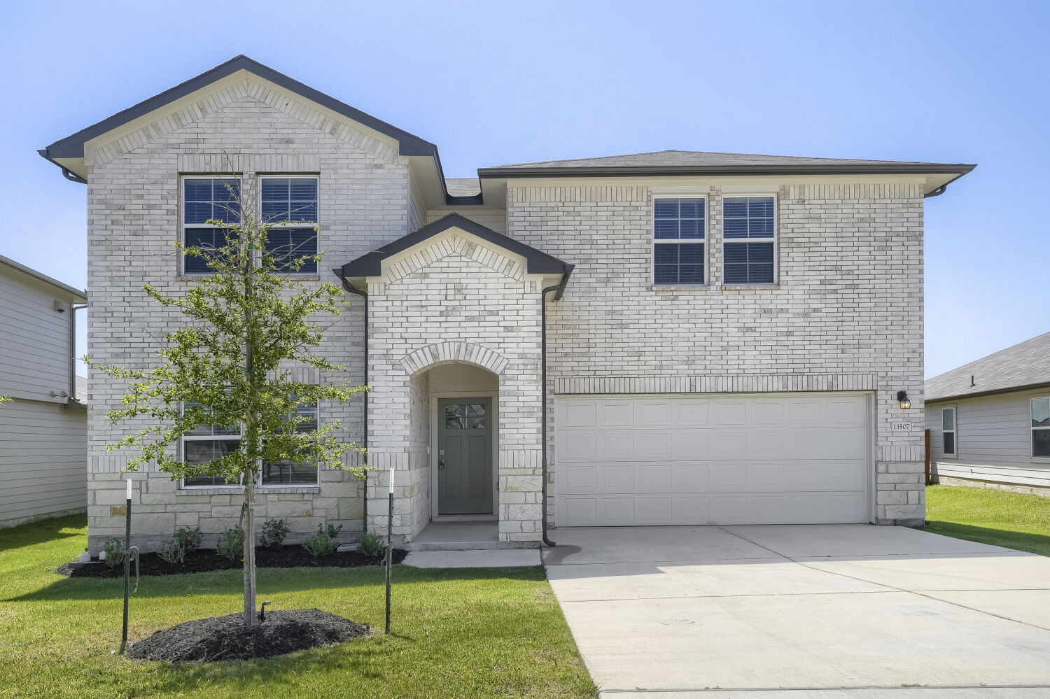 13507 Howser Trace Manor, TX 78653 - Photo 1 of 28 A classic brick facade and a tidy lawn offer appealing curb appeal.
