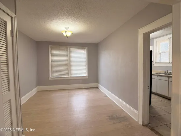 a view of a kitchen with wooden floor and a kitchen