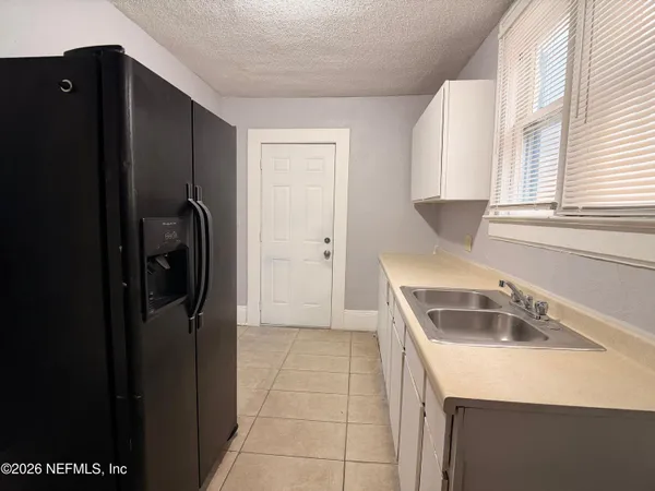 a kitchen with a refrigerator and a sink