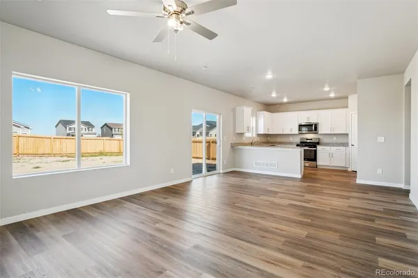 a view of a kitchen with wooden floor and a kitchen