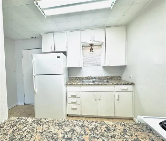 a kitchen with a refrigerator and a stove